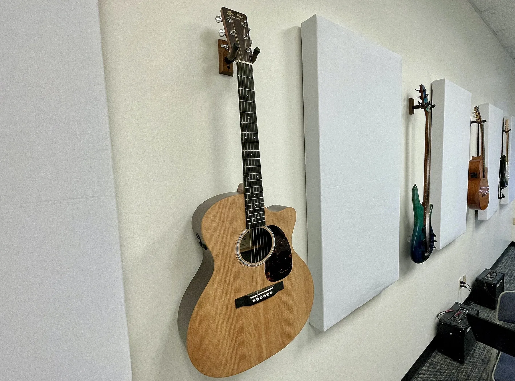 folk acoustic guitar against the wall