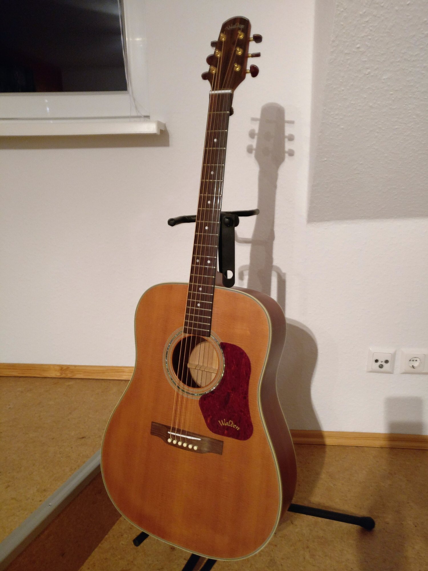 Image de guitare acoustique Gros plan sur des mains jouant une guitare dans une lumière tamisée
