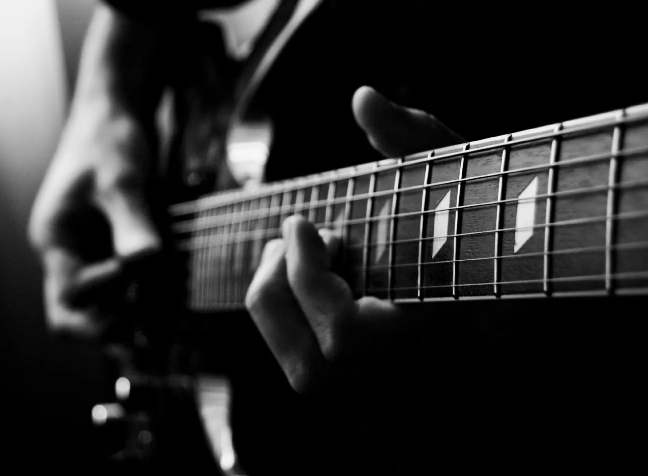 hand playing guitar strings