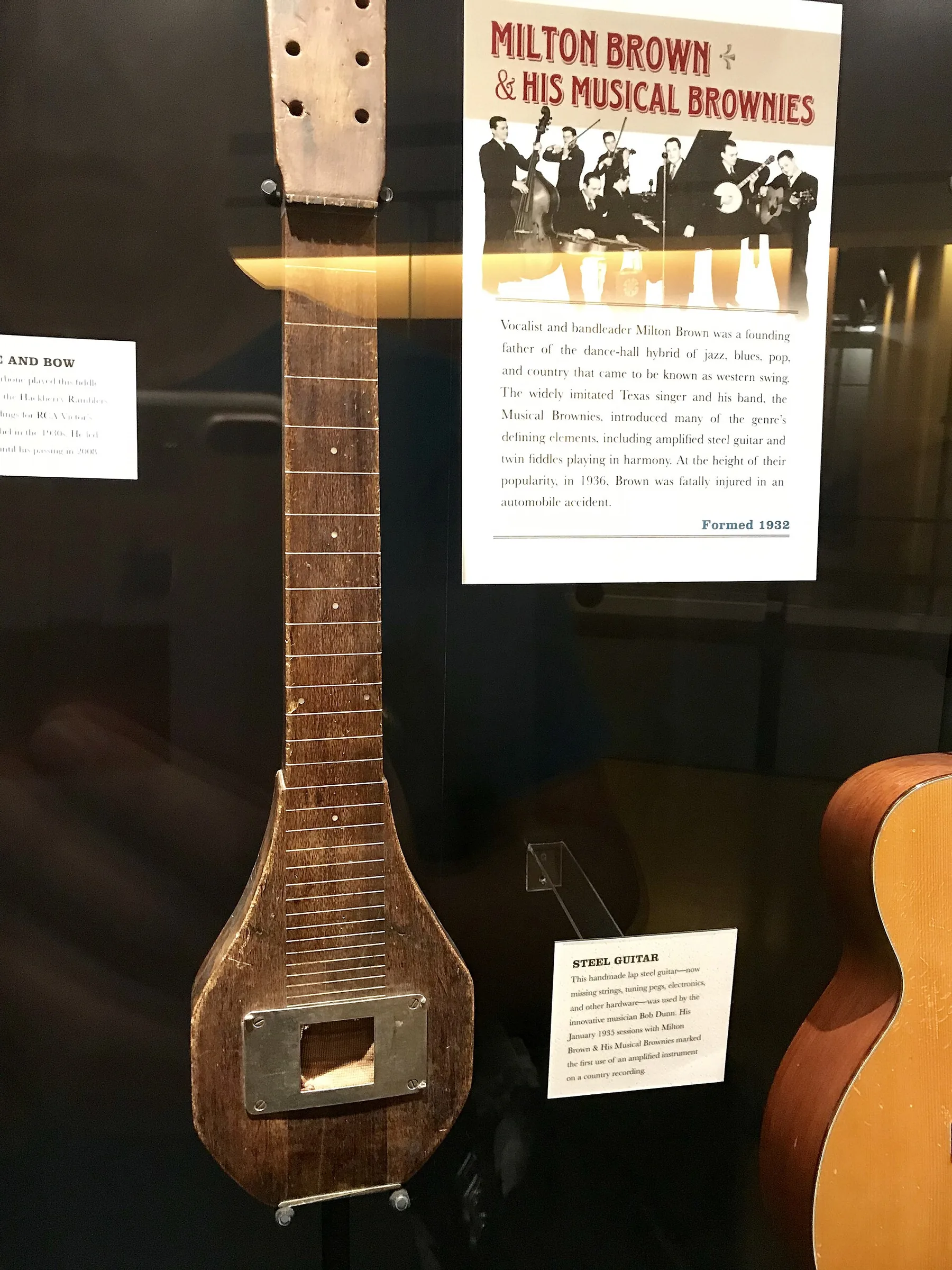 old guitar displayed in a museum