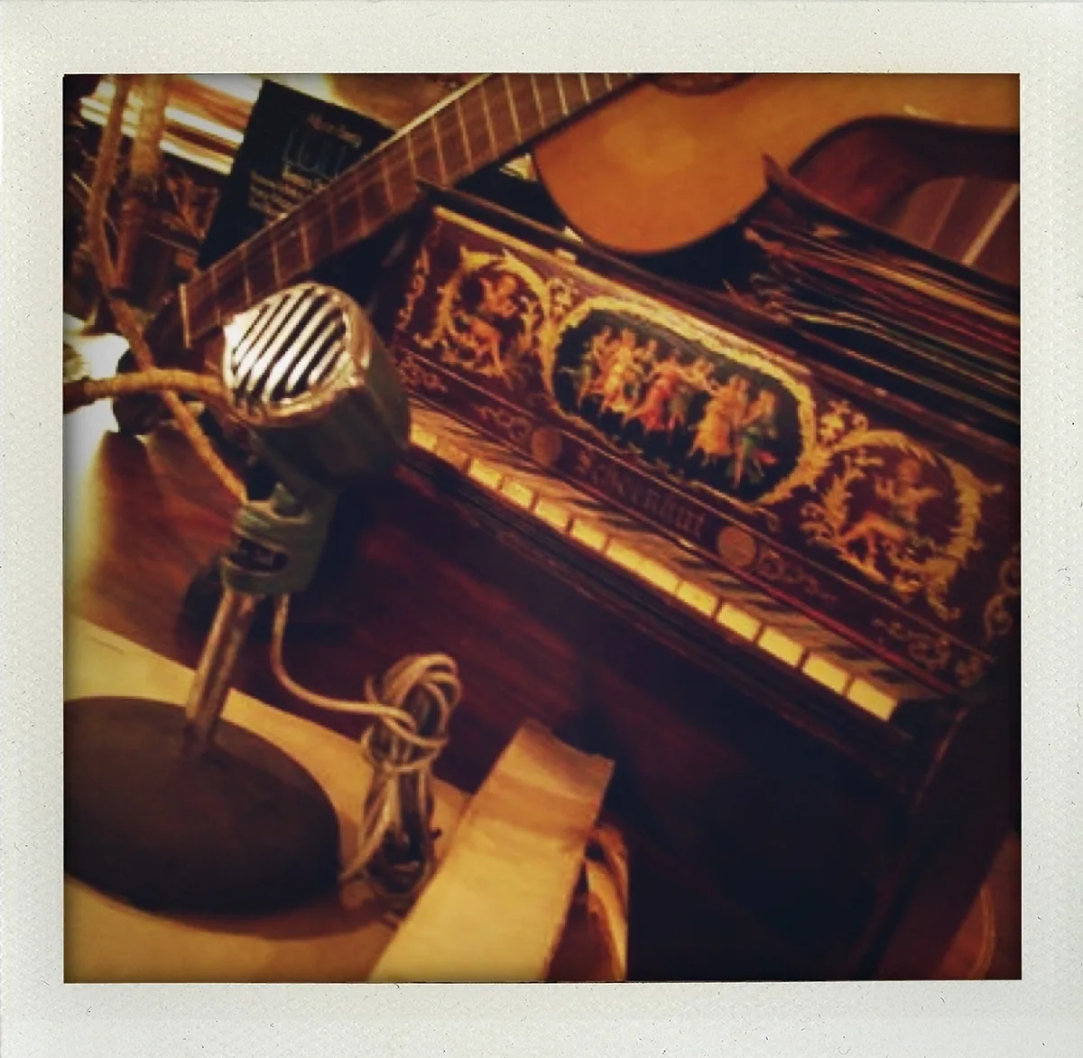 microphone in front of an acoustic guitar